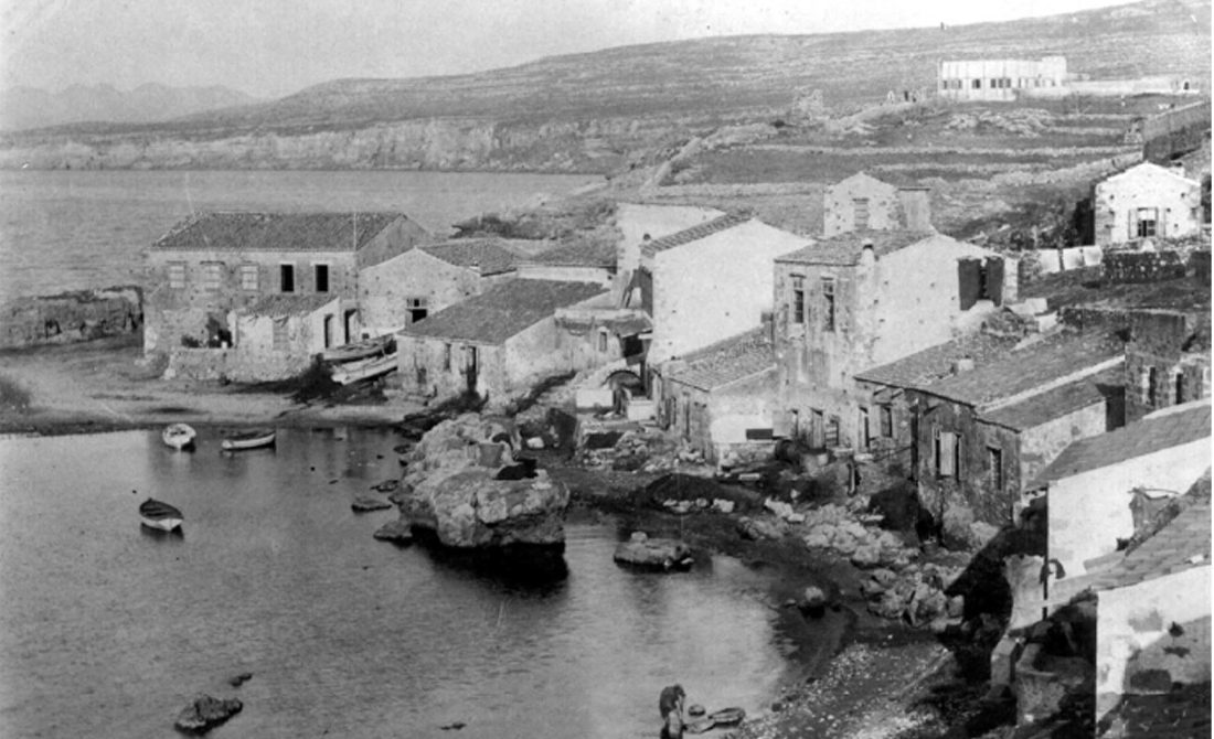 Archive photograph of the tannery district, stone buildings around a small cove with boats drawn up on the shore