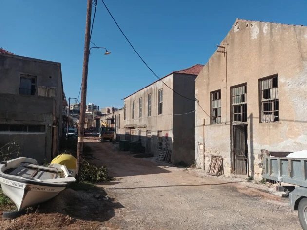The lane between tanneries, a small boat pulled up beside a wall, buildings on both sides